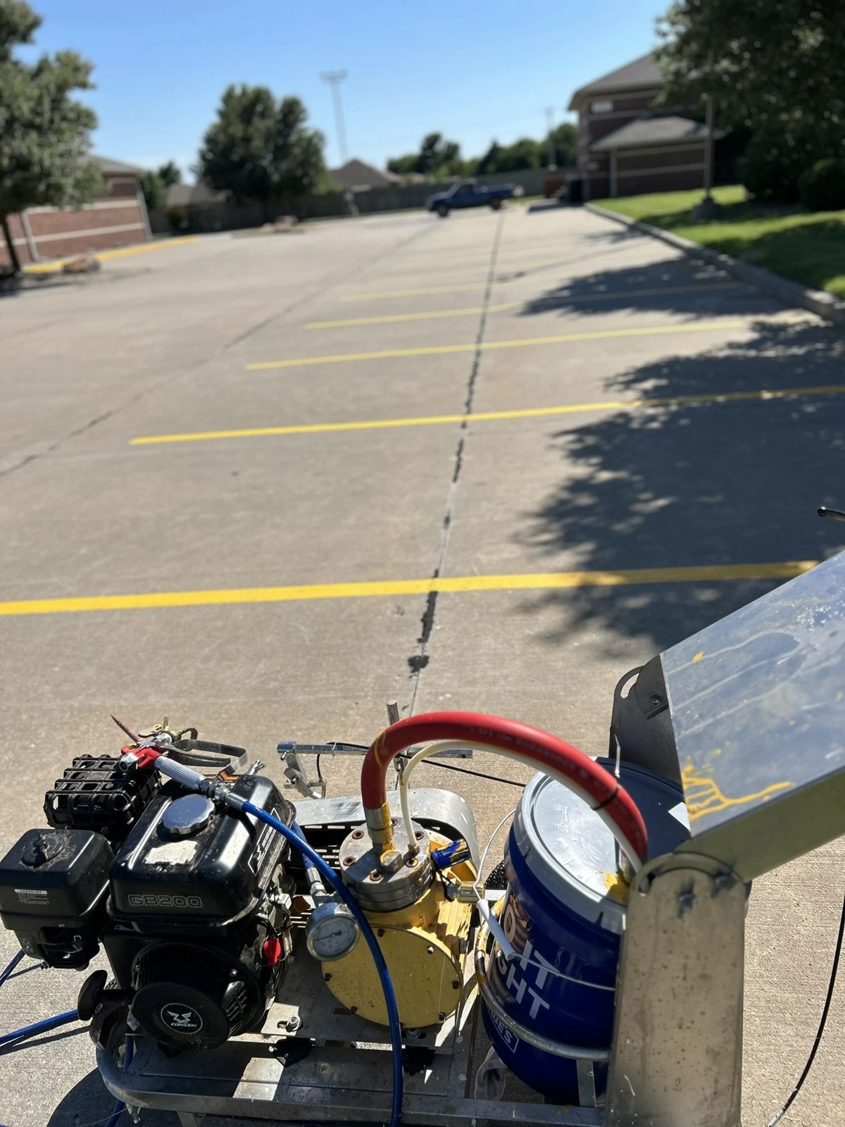Professional line striping equipment on a commercial parking lot