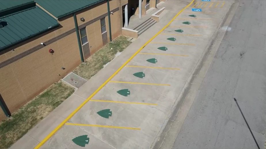 Aerial drone view of parking lot with numbered directional stencils and ADA spaces