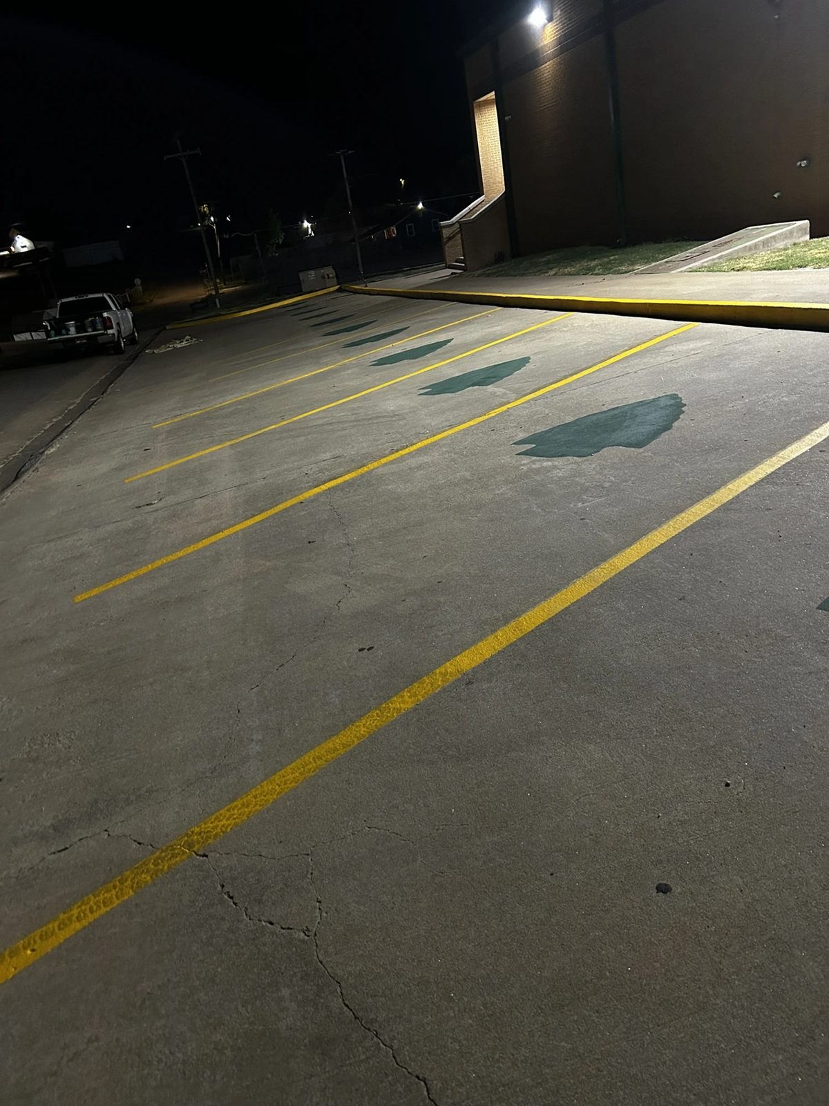 Fresh yellow stall lines and green custom stencil markings applied at night